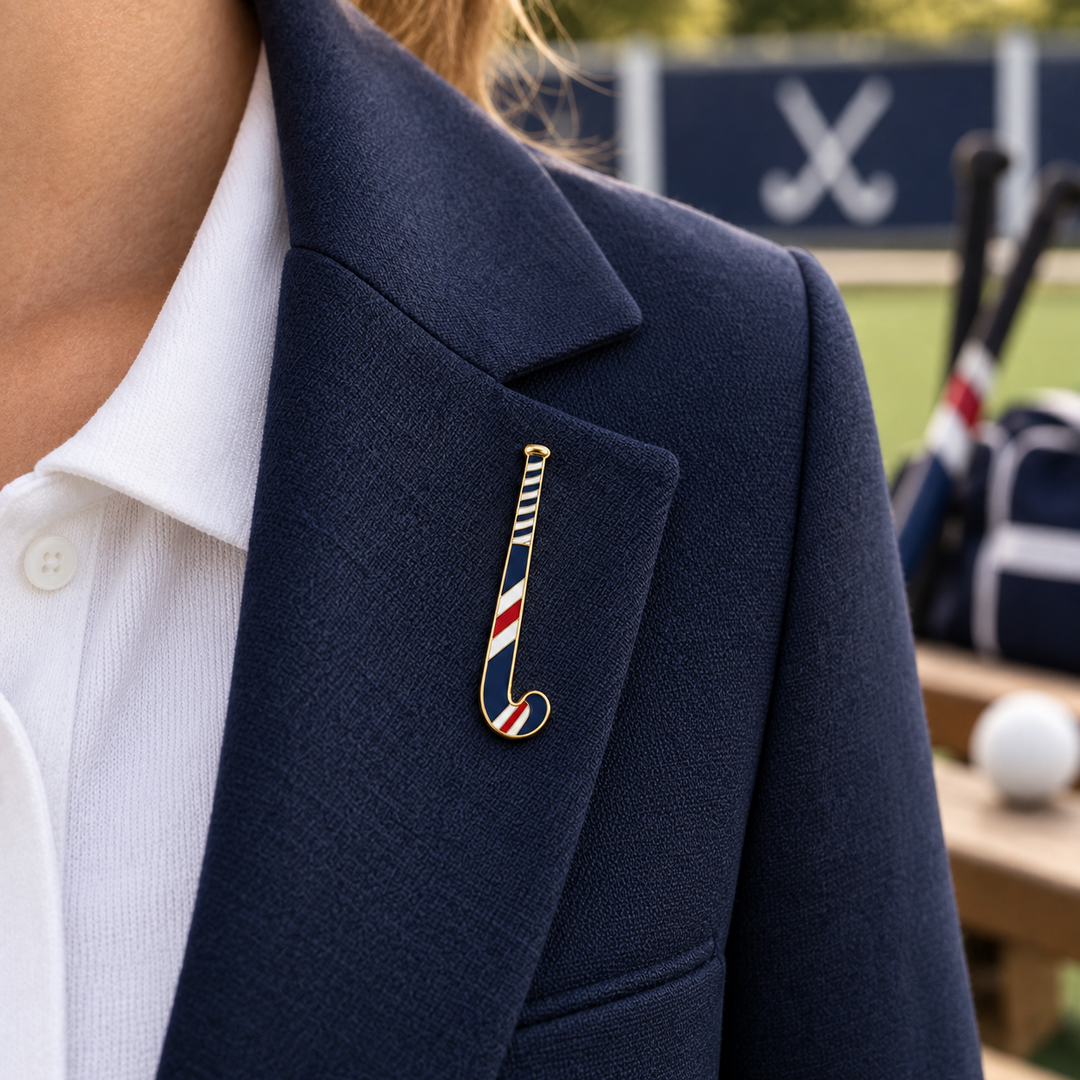 Custom field hockey stick pin shown at approximately 5cm on a navy blazer
