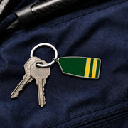Custom rowing oar keychain attached to keys on a navy rowing bag