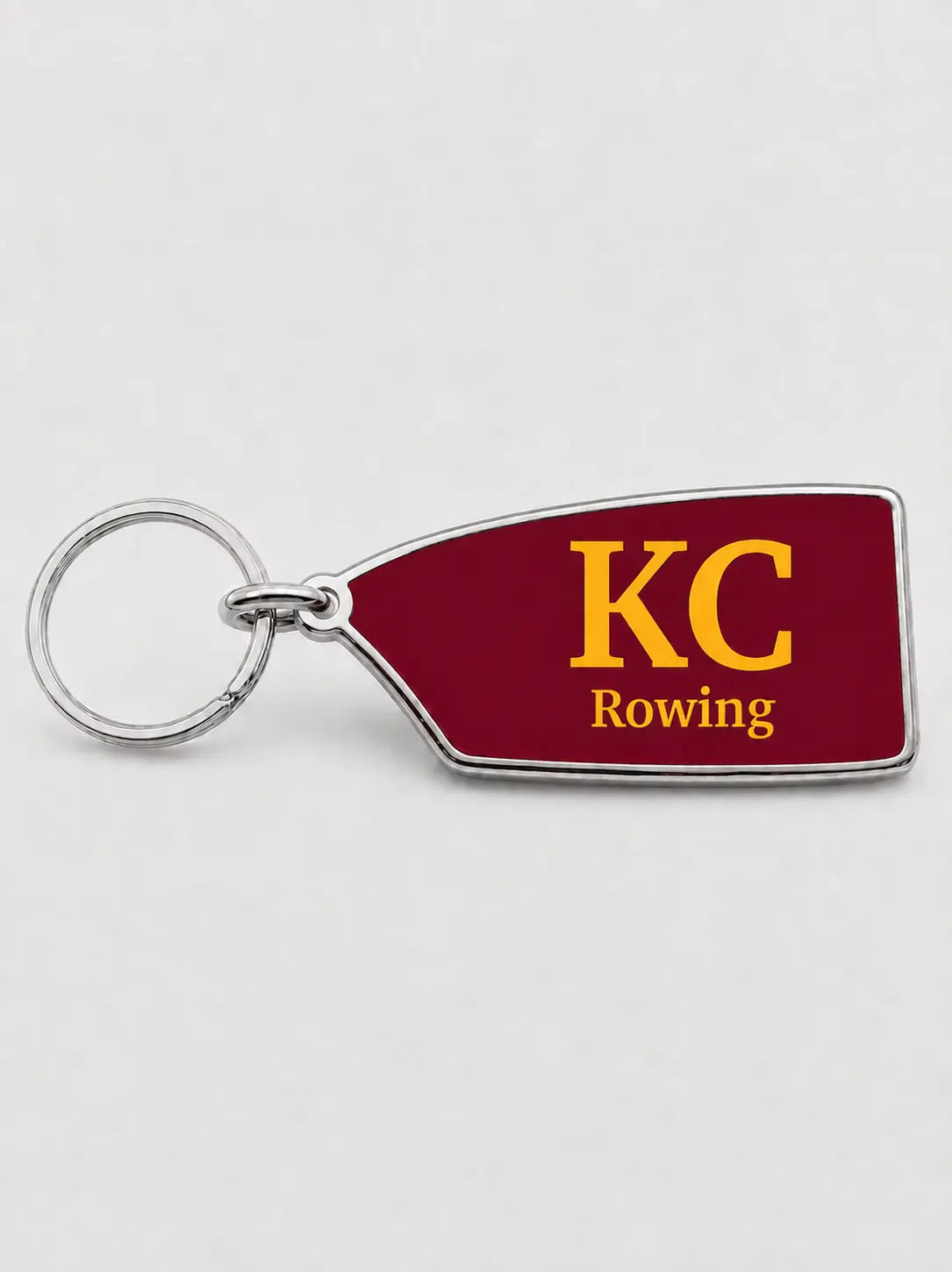 Custom King's College rowing oar keychain in maroon and gold